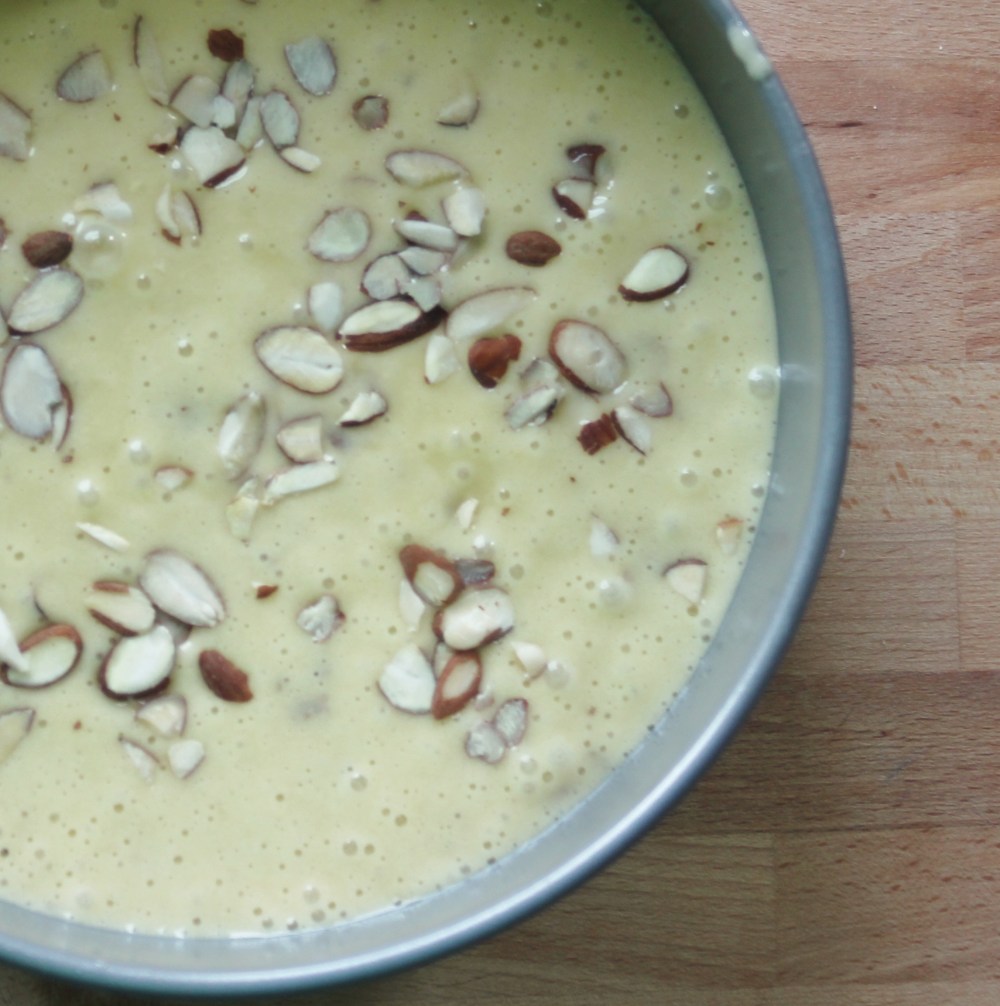 Sprinkle the sliced almonds on top of the unbaked cake.